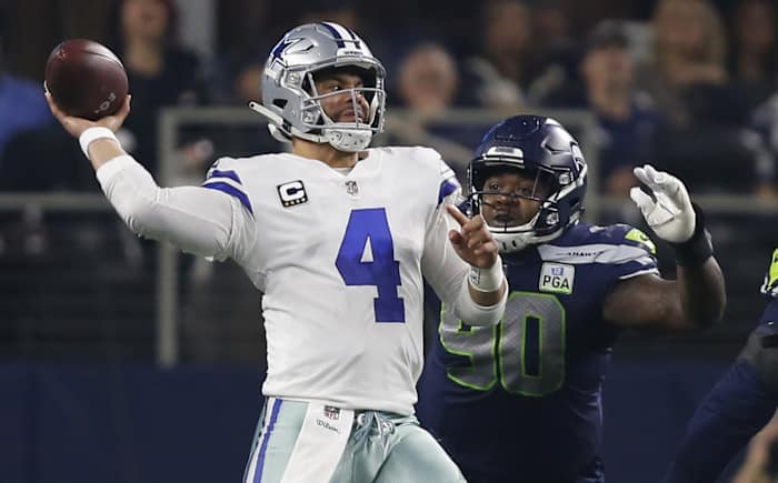 Dallas Cowboys quarterback Dak Prescott (4) throws a pass in the first quarter against the Seattle Seahawks in a NFC Wild Card playoff football game at AT&T Stadium.